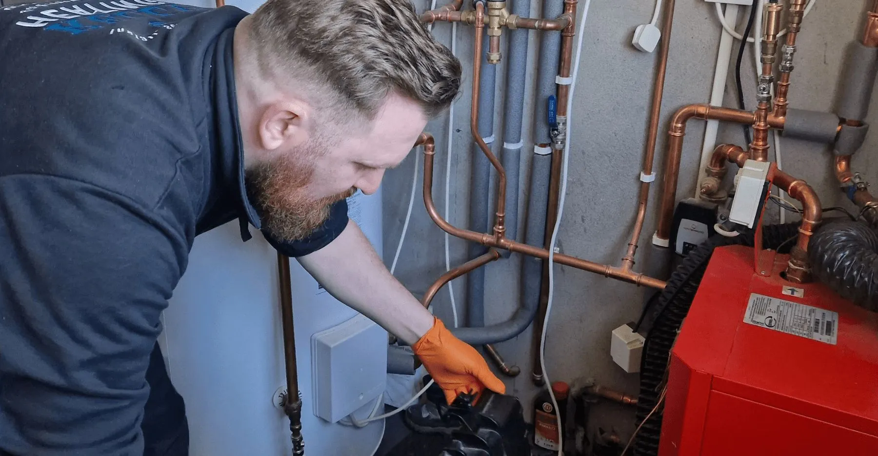 Kieran Kelly working on an oil boiler installation — copper pipework and CenterStore cylinder, Belfast and Lisburn area